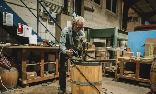 Cooper working on an oak barrel in the workshop