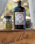 Monkey 47 Distiller's Cut 2024 bottle with glass on a Pantelleria caper crate