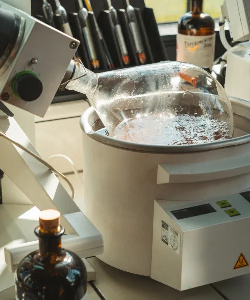 Rotary evaporator in the lab next to a Monkey 47 bottle