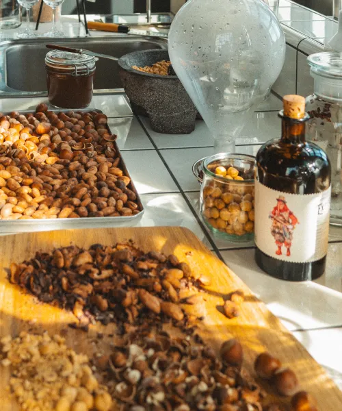 Dried botanicals and nuts beside a Monkey 47 Experimentum Series 2y09 bottle