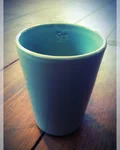 Monkey 47 The Becher, a blue ceramic cup on a wooden table