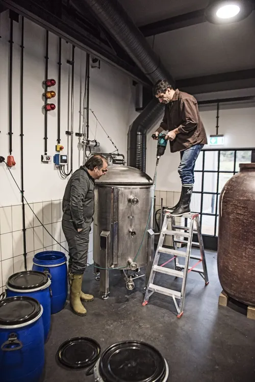 Distillers working at the copper still in the Monkey 47 distillery