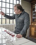 Monkey 47 distiller nosing a glass of Schwarzwald Sloe Gin at a tasting counter