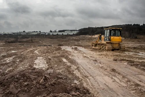 Bulldozer working in a muddy clay pit