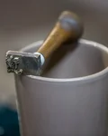 Stamp pressing the Monkey 47 mark into the base of a Becher cup