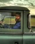 Man at the wheel of an old pickup truck