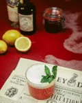 A Mountie in the Black Forest cocktail with mint and a Monkey 47 bottle