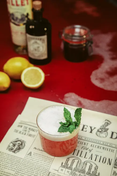 A Mountie in the Black Forest cocktail with mint and a Monkey 47 bottle
