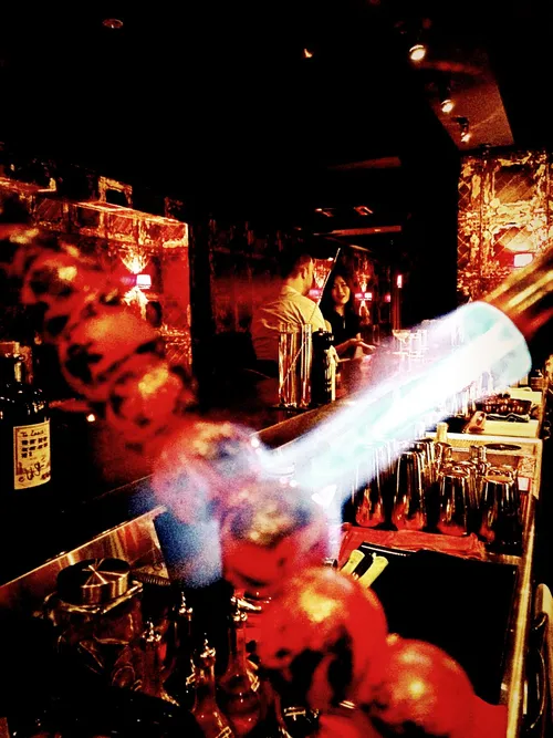 Bartender torching a garnish at L'Aiglon