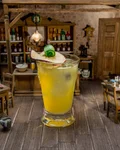 Monkey le Gurk highball with cucumber in a miniature saloon setting