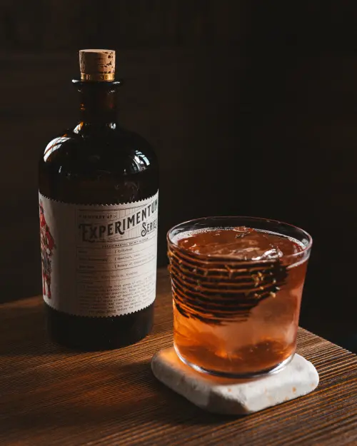 Martinez al Bacio on ice next to a gin bottle