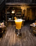 Satan's Whiskers cocktail in a miniature saloon setting