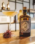 Scarlett's Bee's Knees signature serve with a Monkey 47 bottle