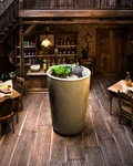 Sloe Gin Soda in a tall cup in a miniature saloon setting