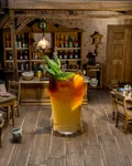 Suffering Bastard with mint and orange in a miniature saloon setting