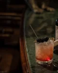 Bramble with blackberries next to a Monkey 47 bottle