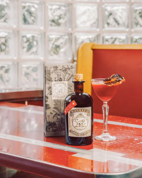 Vallières' Secret cocktail next to a Monkey 47 Distiller's Cut bottle