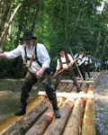Rafters on a log raft floating down a Black Forest river