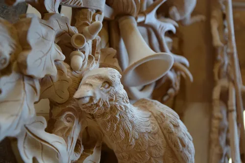 Close-up of a hand-carved cuckoo clock with a bird and leaves