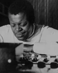 Black-and-white photo of Oscar Peterson playing the piano