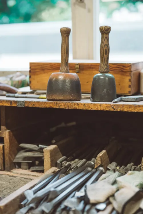 Wooden mallets and chisels on a workbench