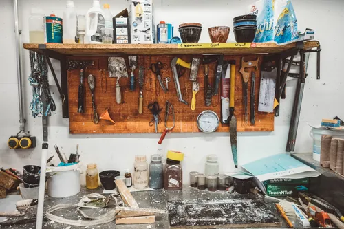 Workbench with tools hanging on a wall rack