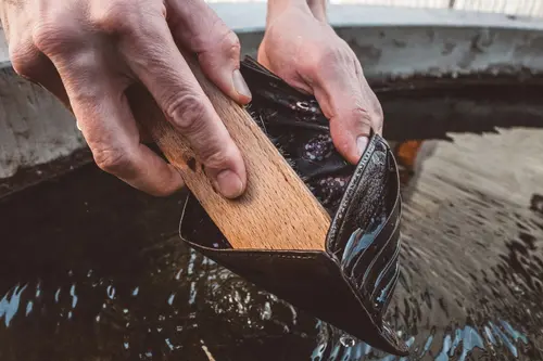 Hand scrubbing with a wooden brush in water