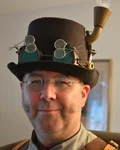 Man in a steampunk top hat with goggles
