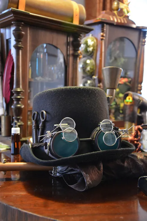 Steampunk top hat with goggles on a table