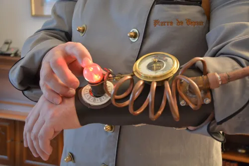 Hand holding a steampunk brass gadget