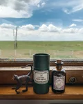 Monkey 47 bottle and a monkey figurine on a train window ledge