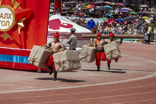 Performers in traditional costume on the Naadam stadium track