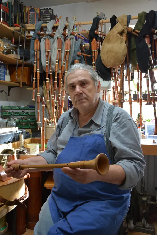 Black Forest piper in his workshop holding a chanter