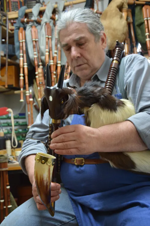 Black Forest piper tuning his bagpipes